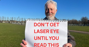 old man holds a sign saying "DON'T GET LASER EYE UNTIL YOU READ THIS"